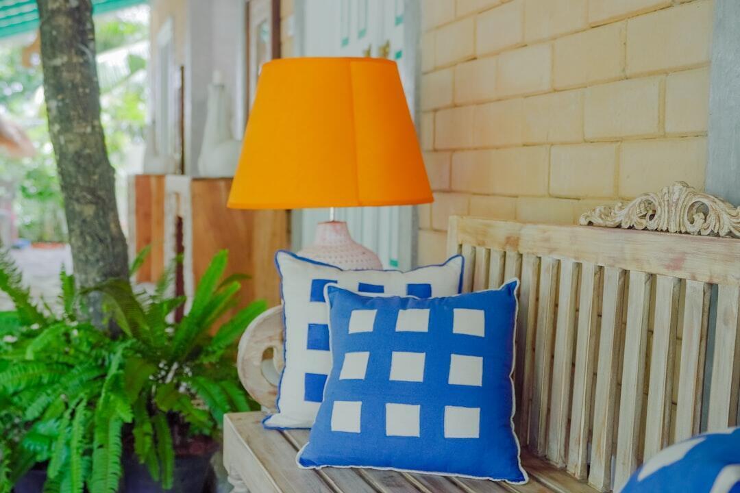 Colorful outdoor patio cushions on wicker furniture in natural sunlight