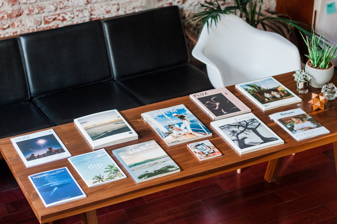 Collection of printed photographs arranged and organized on wooden table for album layout planning