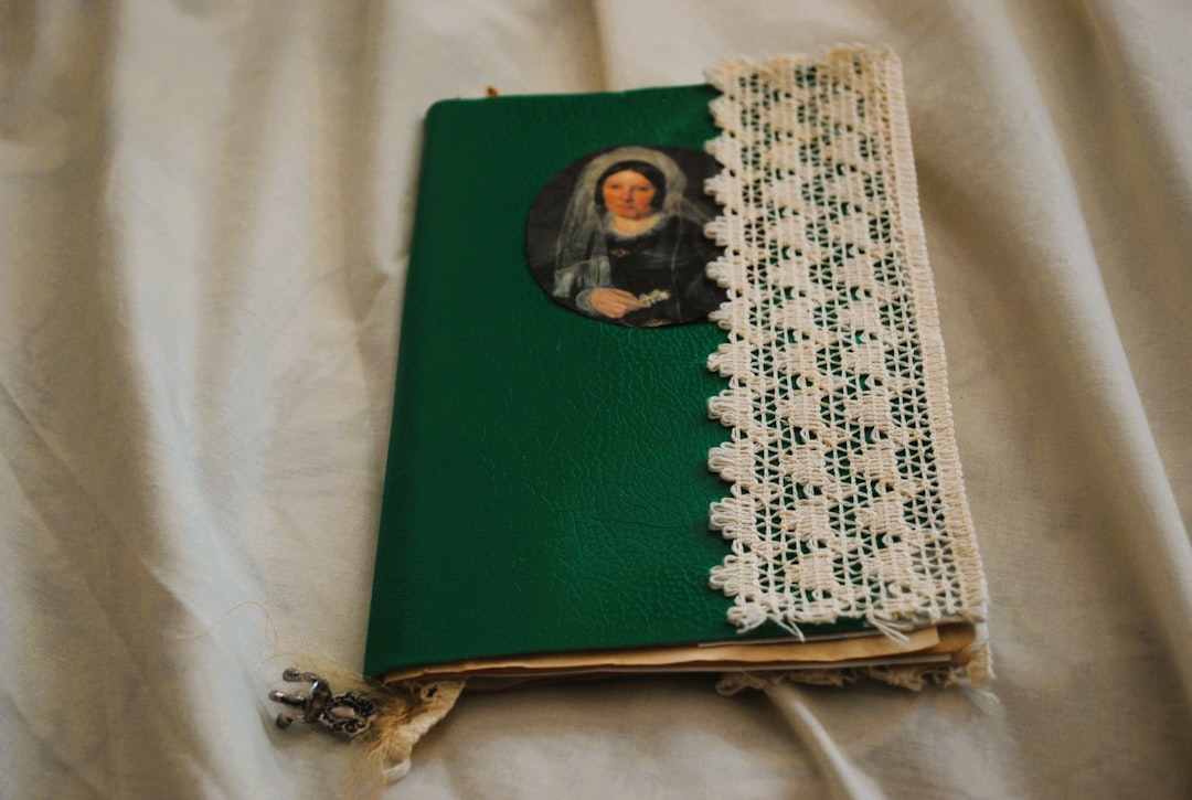 Open scrapbook-style photo album showing decorated pages with photos, handwritten notes, and vintage embellishments