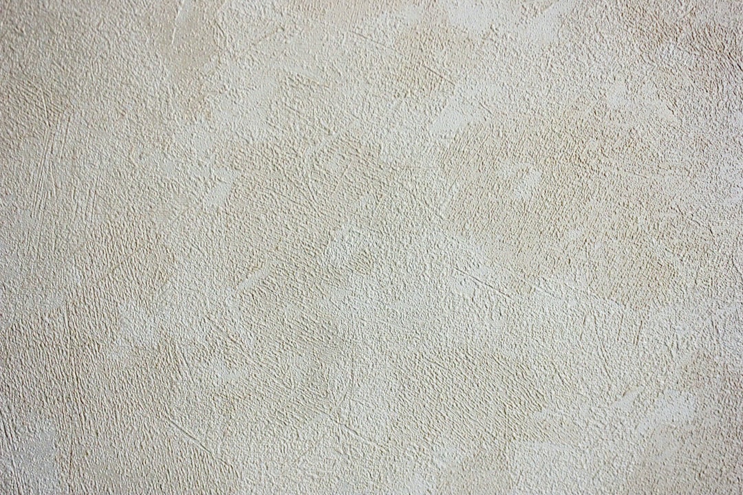 Plastic bag filled with ice cubes placed on hardened candle wax on gray carpet