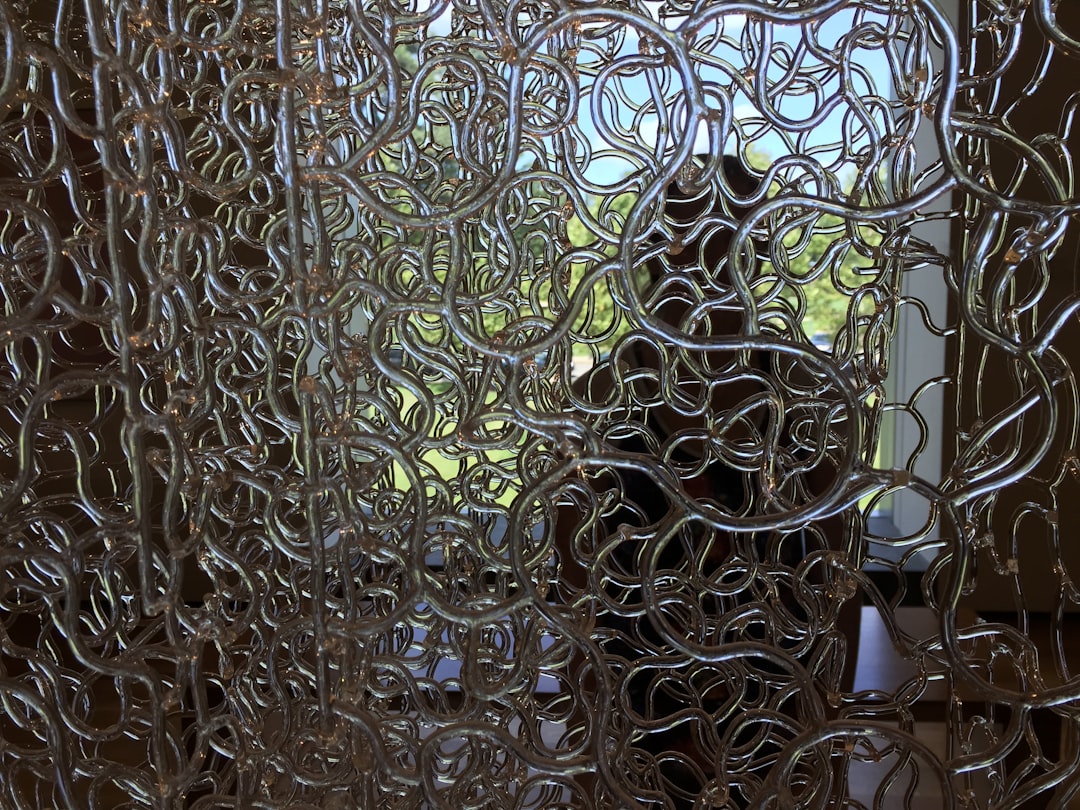 Beautiful seasonal wreath hanging on glass paneled front door with natural lighting