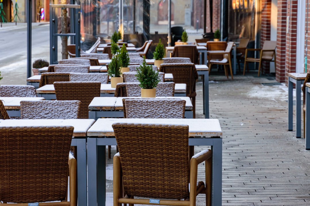 Comfortable teak lounge chairs beside swimming pool with cushions