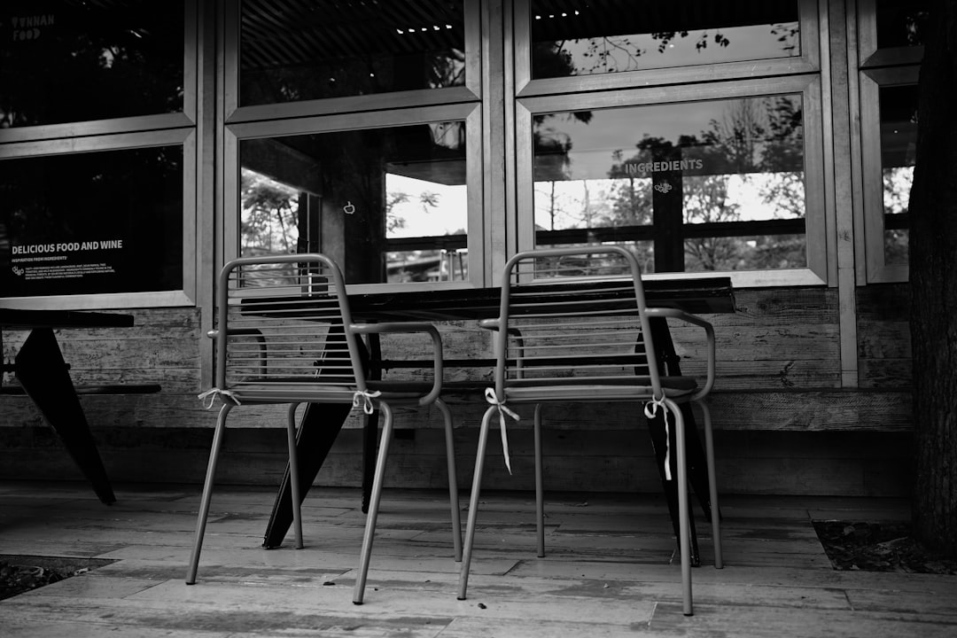 White wicker outdoor furniture set with blue striped cushions in coastal style