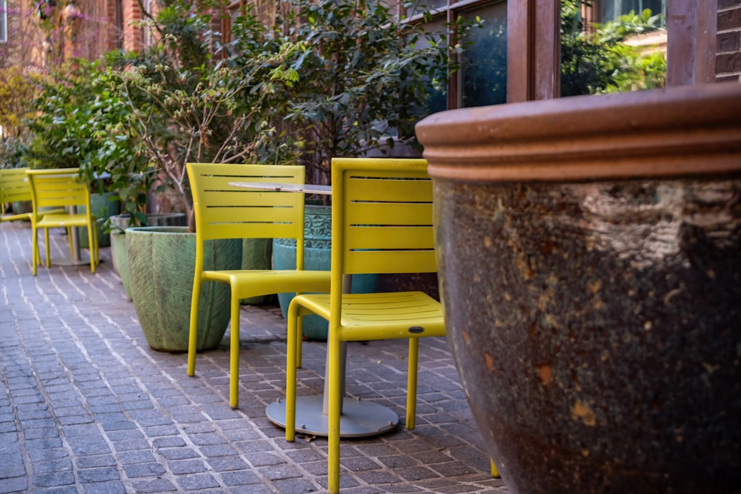 Outdoor sofa with vibrant patterned cushions and decorative throw pillows