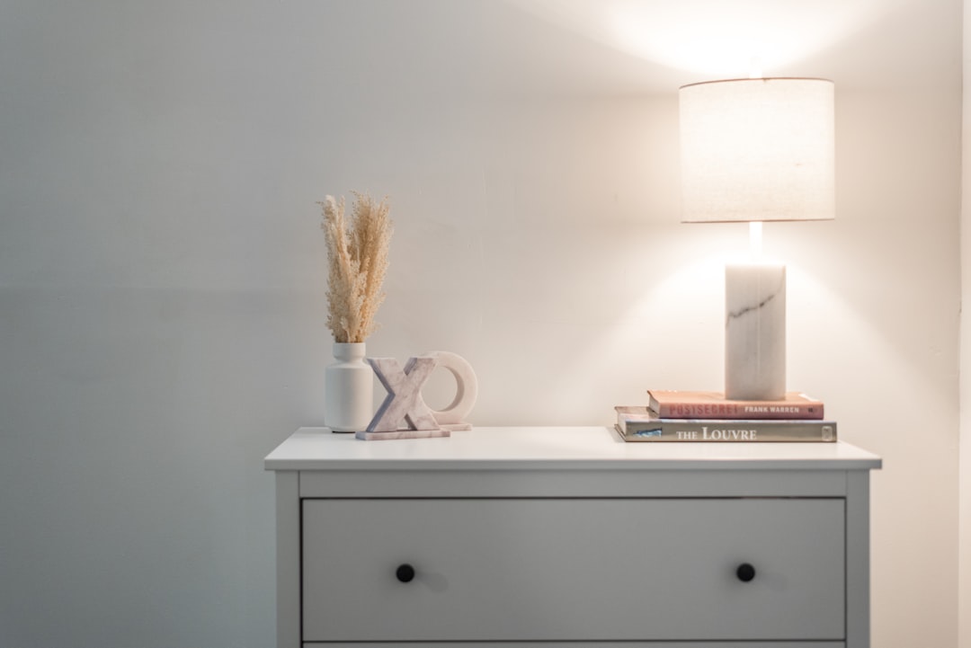 Beautiful mid-priced candles arranged on nightstand in contemporary bedroom setting