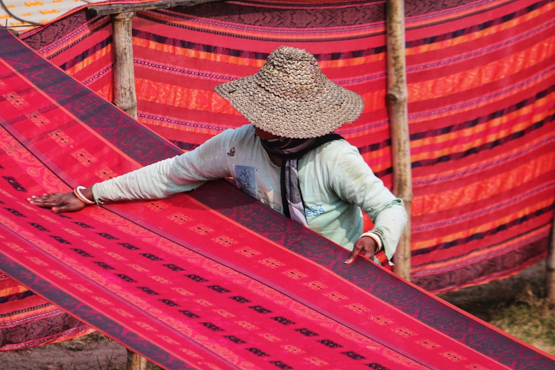 Modern patio featuring a vibrant geometric polypropylene outdoor rug under wicker furniture