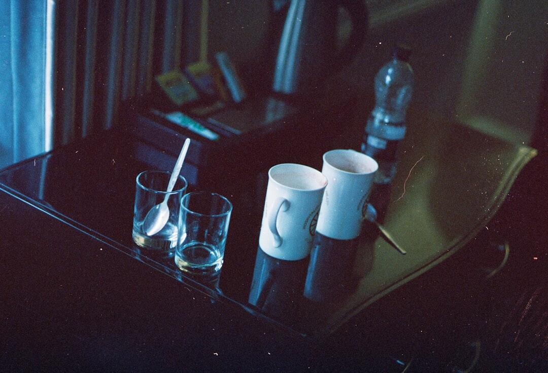 Three high-quality candles burning on modern coffee table with soft ambient lighting