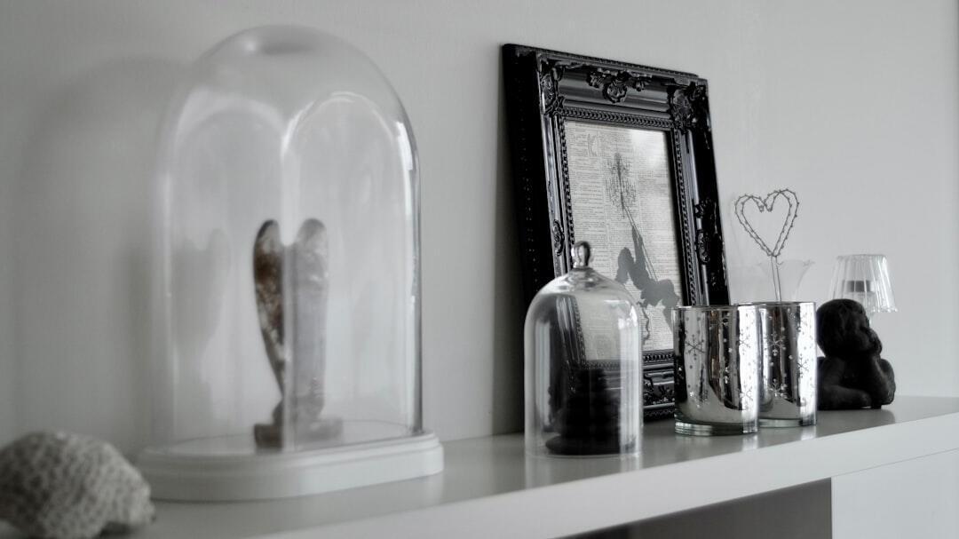 Curated collection of elegant candles displayed on floating wooden shelf